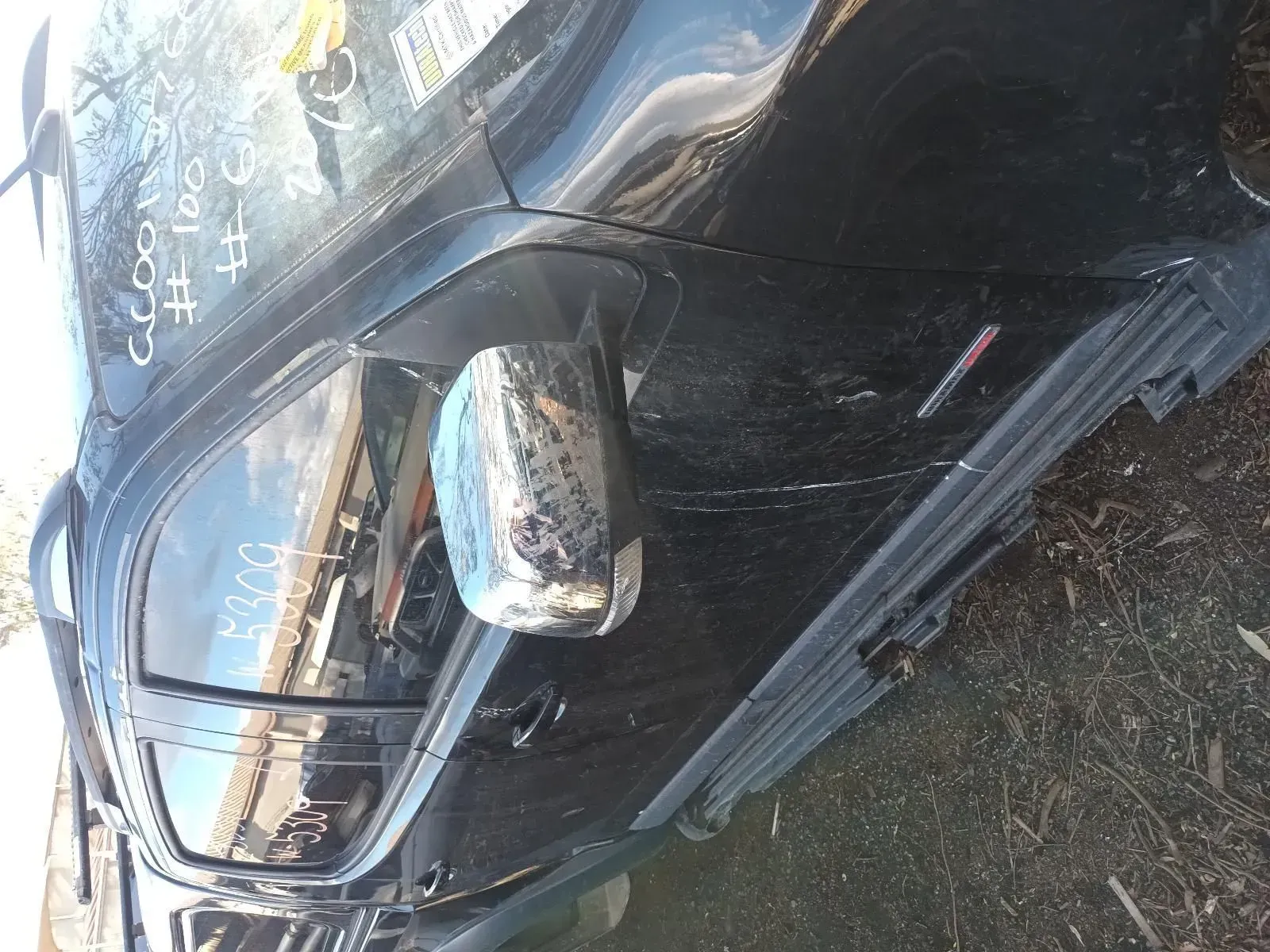 Black Car Side With a Side Mirror and a Red Emblem, Outdoors — South West 4WD Wreckers In Brisbane, QLD