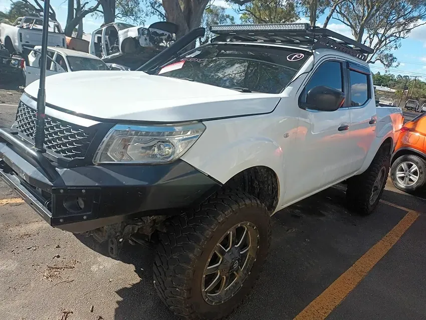 A White Truck with a Roof Rack is Parked in a Parking Lot — South West 4WD Wreckers In Brisbane, QLD