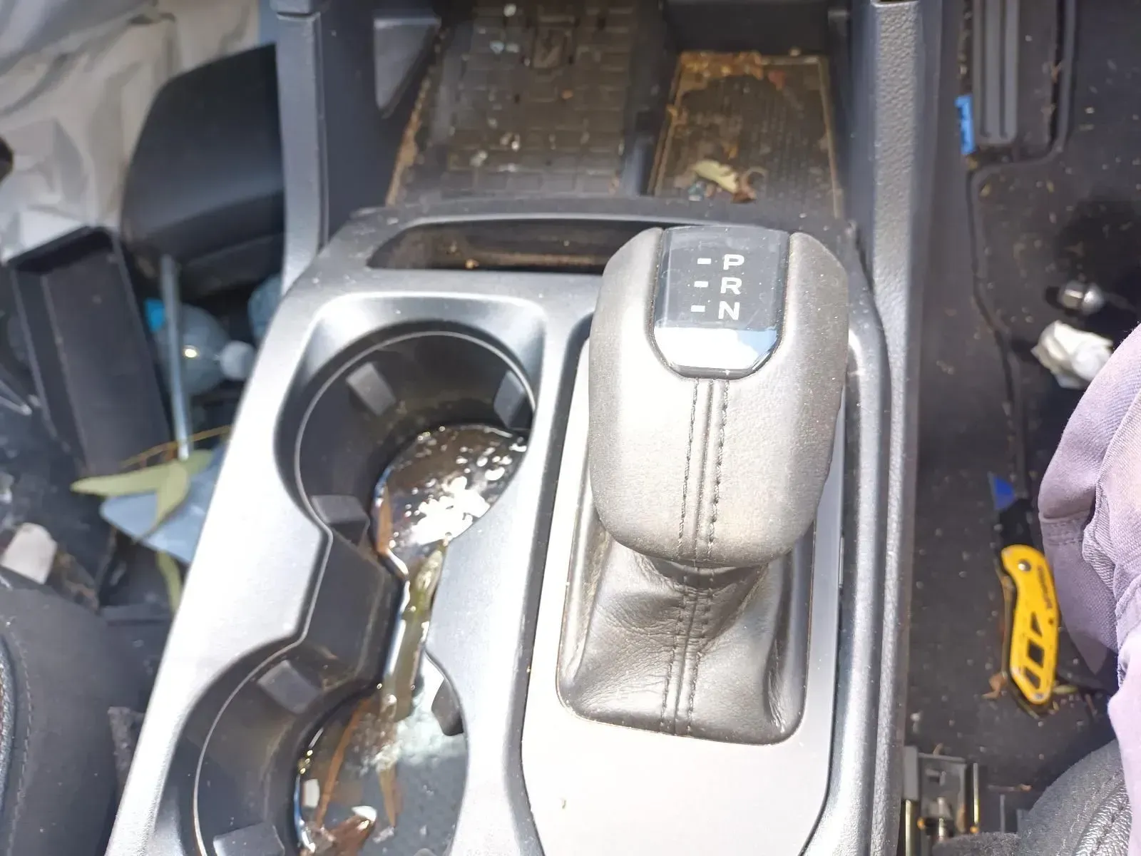 Dirty Car Console With Gear Shift, Cup Holders, and Debris — South West 4WD Wreckers In Brisbane, QLD