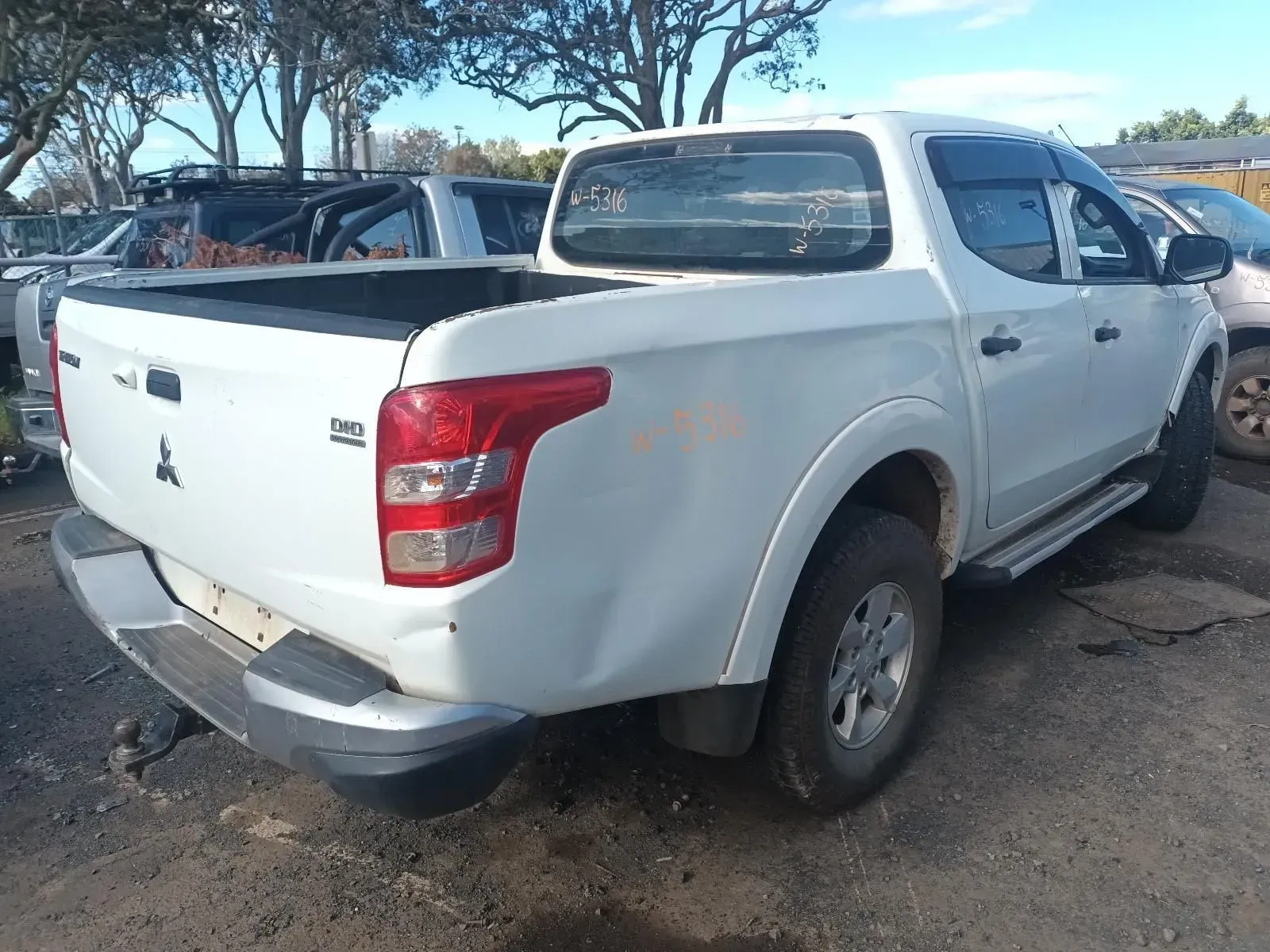 White Mitsubishi Pickup Truck, Parked Outdoors — South West 4WD Wreckers In Brisbane, QLD