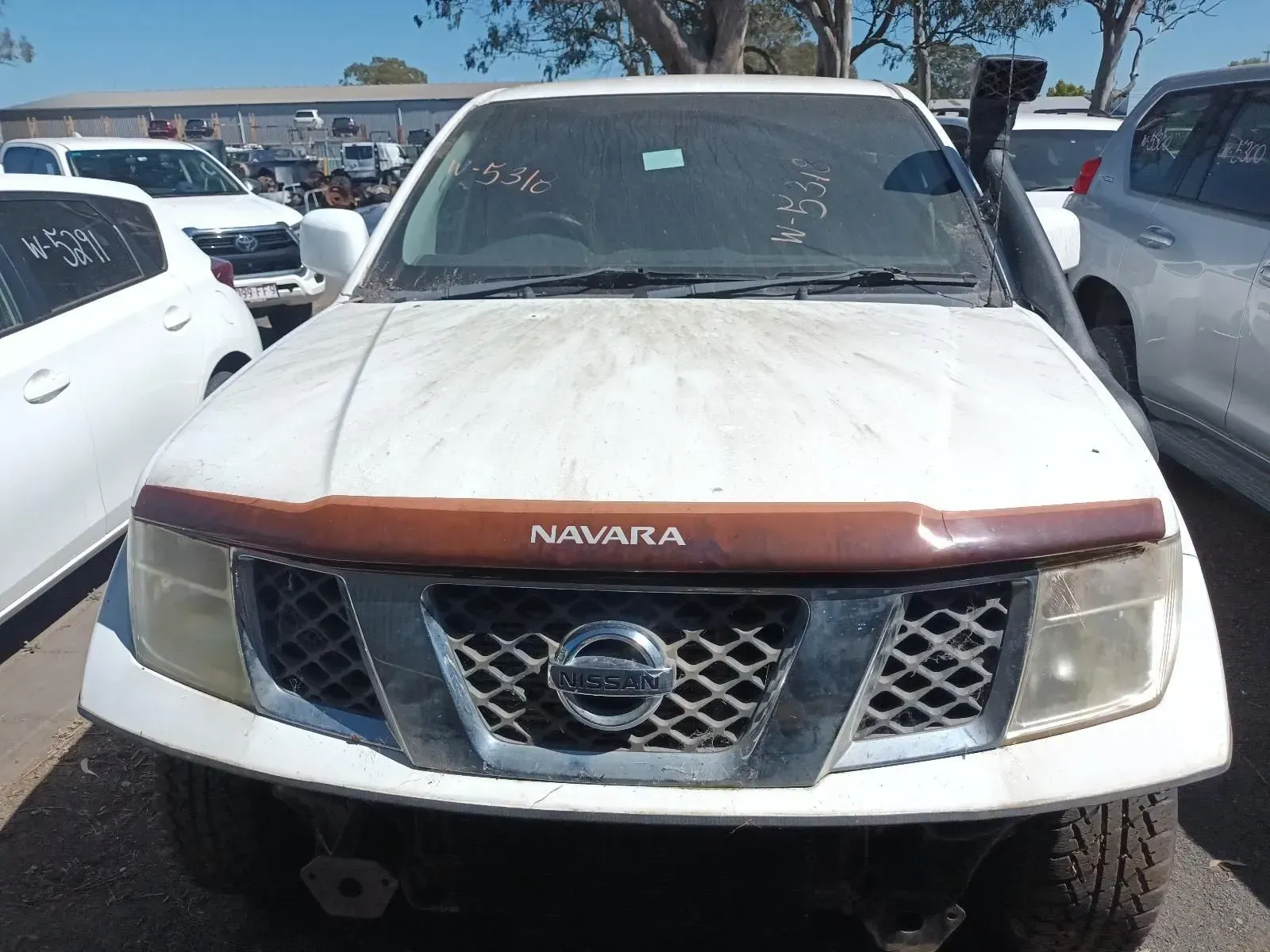 White Nissan Navara Pickup Truck at a Junkyard — South West 4WD Wreckers In Brisbane, QLD