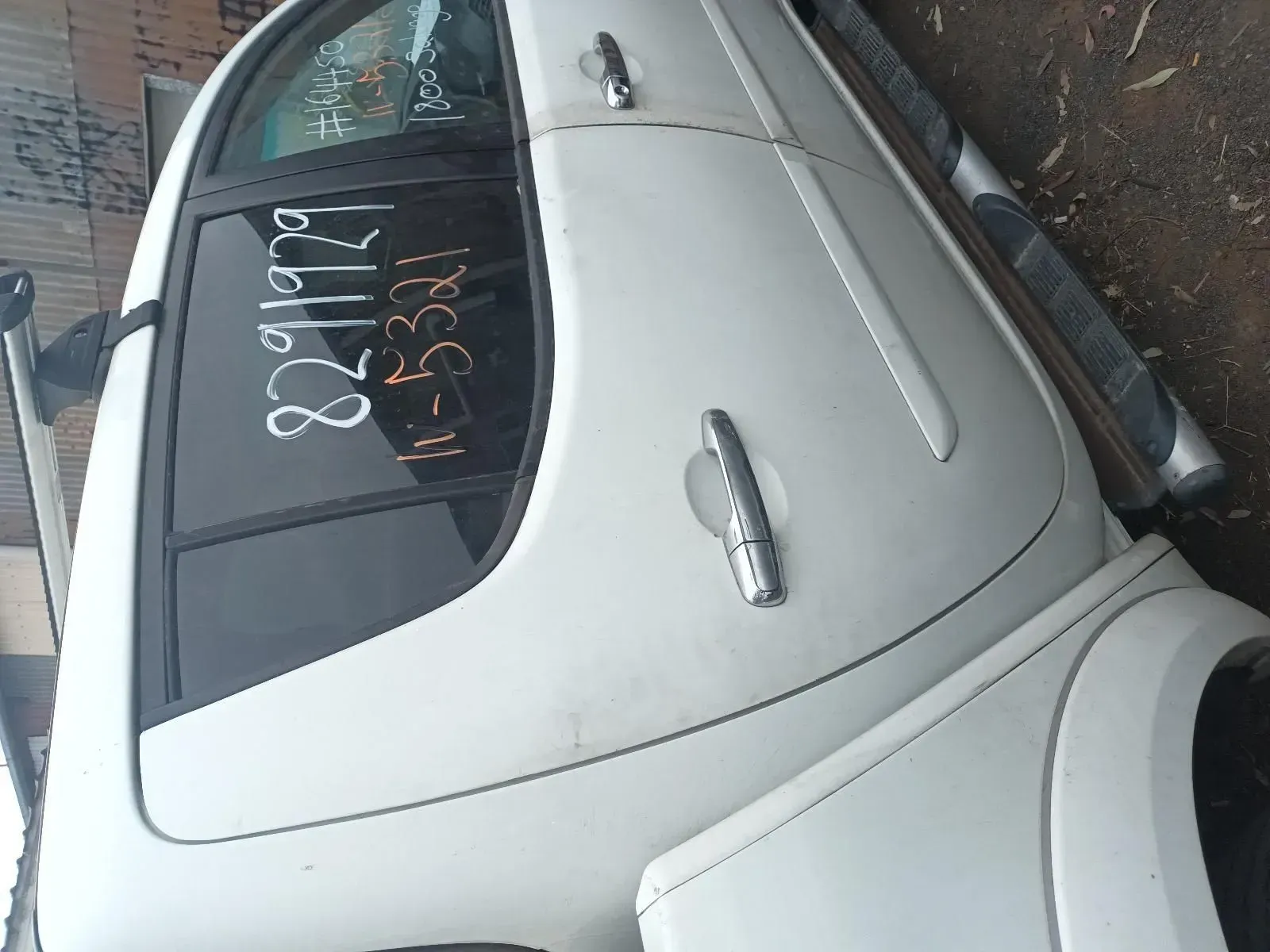 White Vehicle Side With a Door Handle and Side Step, in an Outdoor Setting — South West 4WD Wreckers In Brisbane, QLD