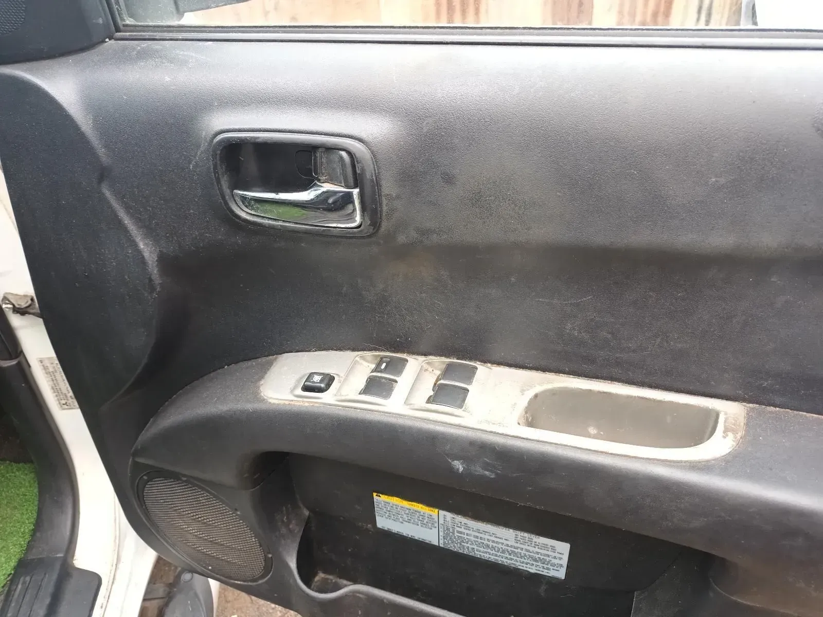 Car Door Panel With a Black Finish, Chrome Handle, and Power Window Controls — South West 4WD Wreckers In Brisbane, QLD