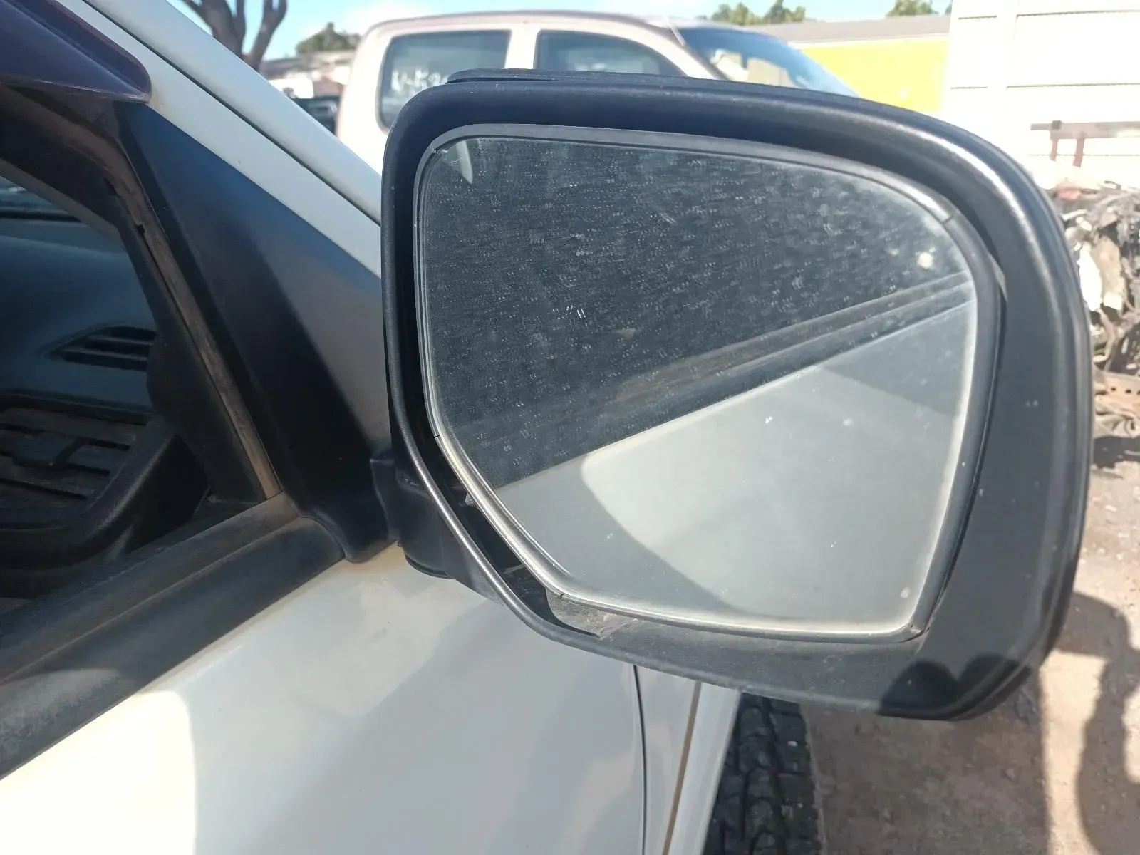 Side View Mirror on a White Car, Dusty and Showing a Road Reflection — South West 4WD Wreckers In Brisbane, QLD