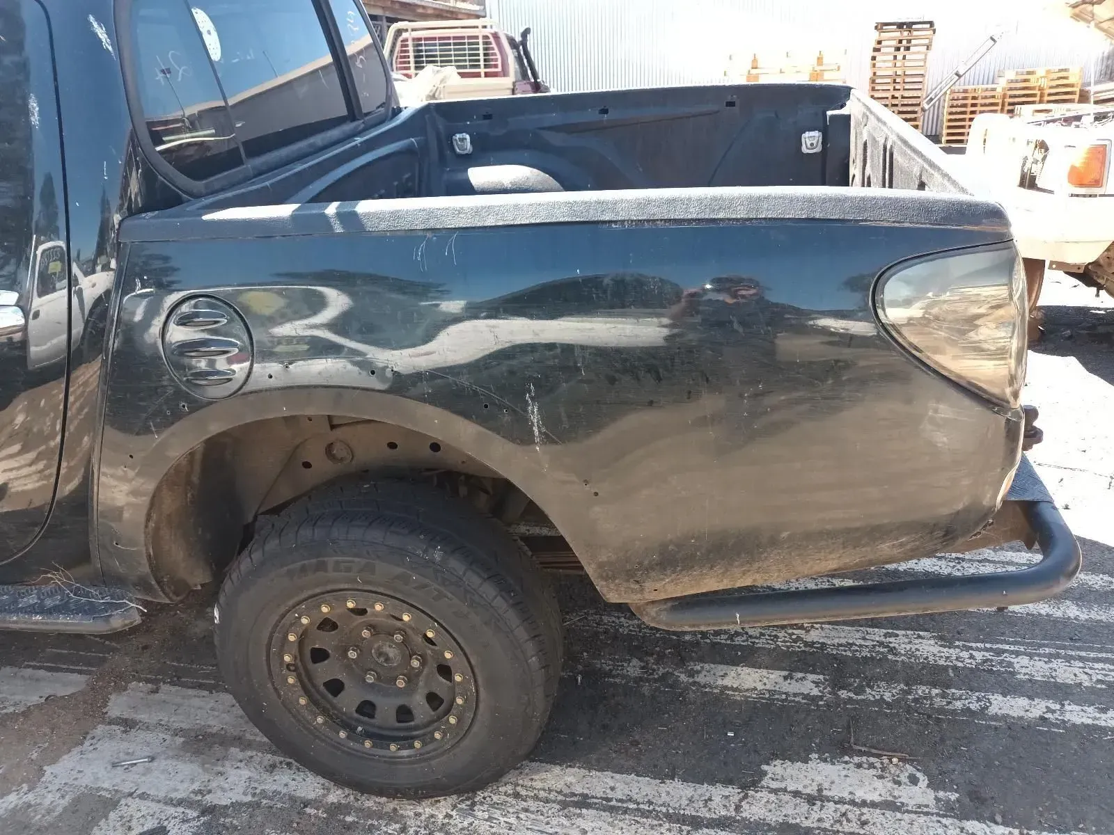 Black Pickup Truck Bed, Rear Tyre Visible, Outdoors — South West 4WD Wreckers In Brisbane, QLD