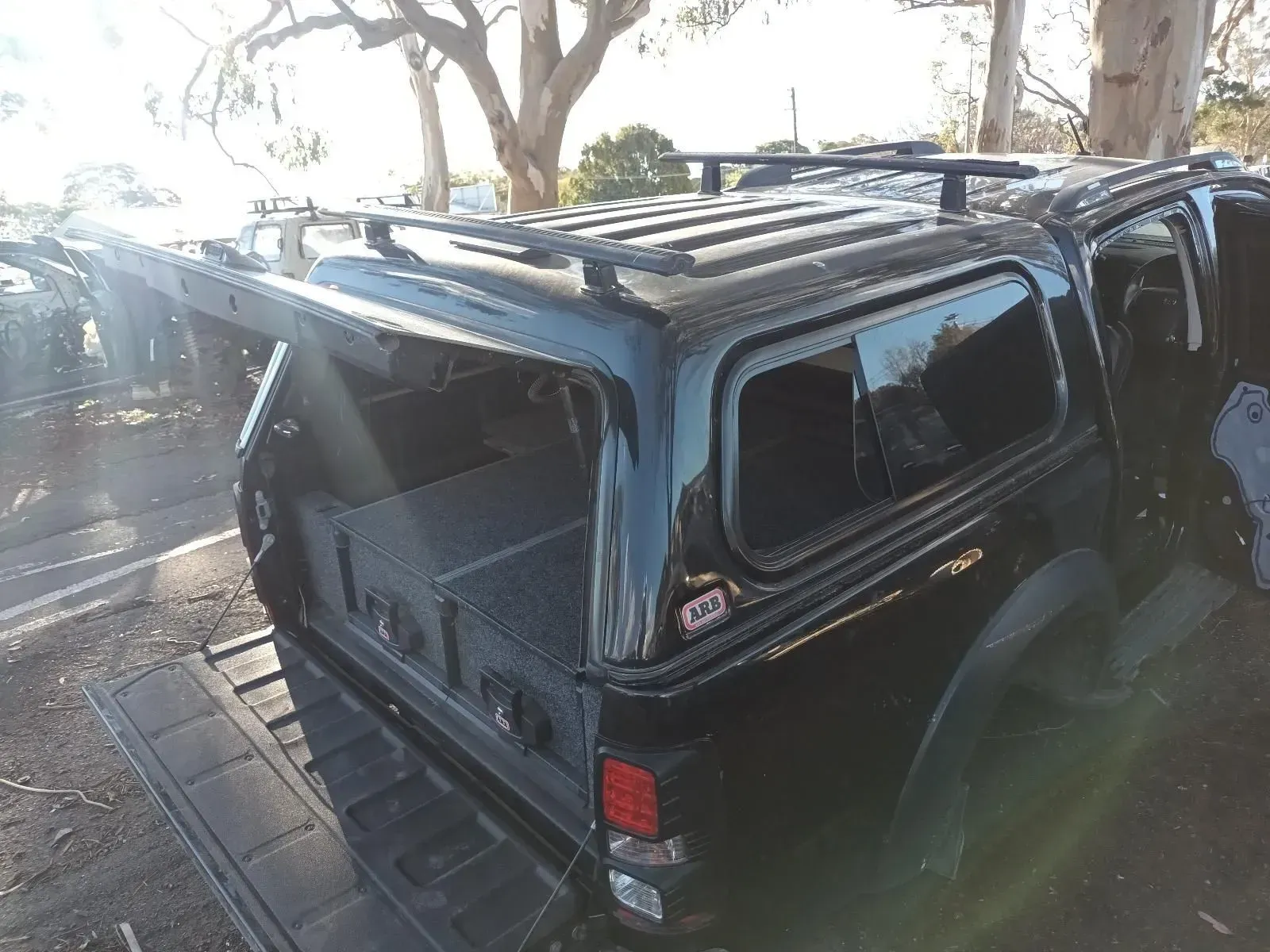 Black Pickup Truck With a Canopy, Open Side Doors, and Roof Rack — South West 4WD Wreckers In Brisbane, QLD