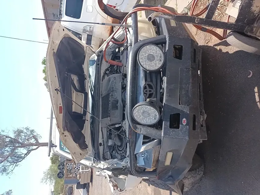 A Car With the Hood Up is Parked on the Side of the Road — South West 4WD Wreckers In Brisbane, QLD