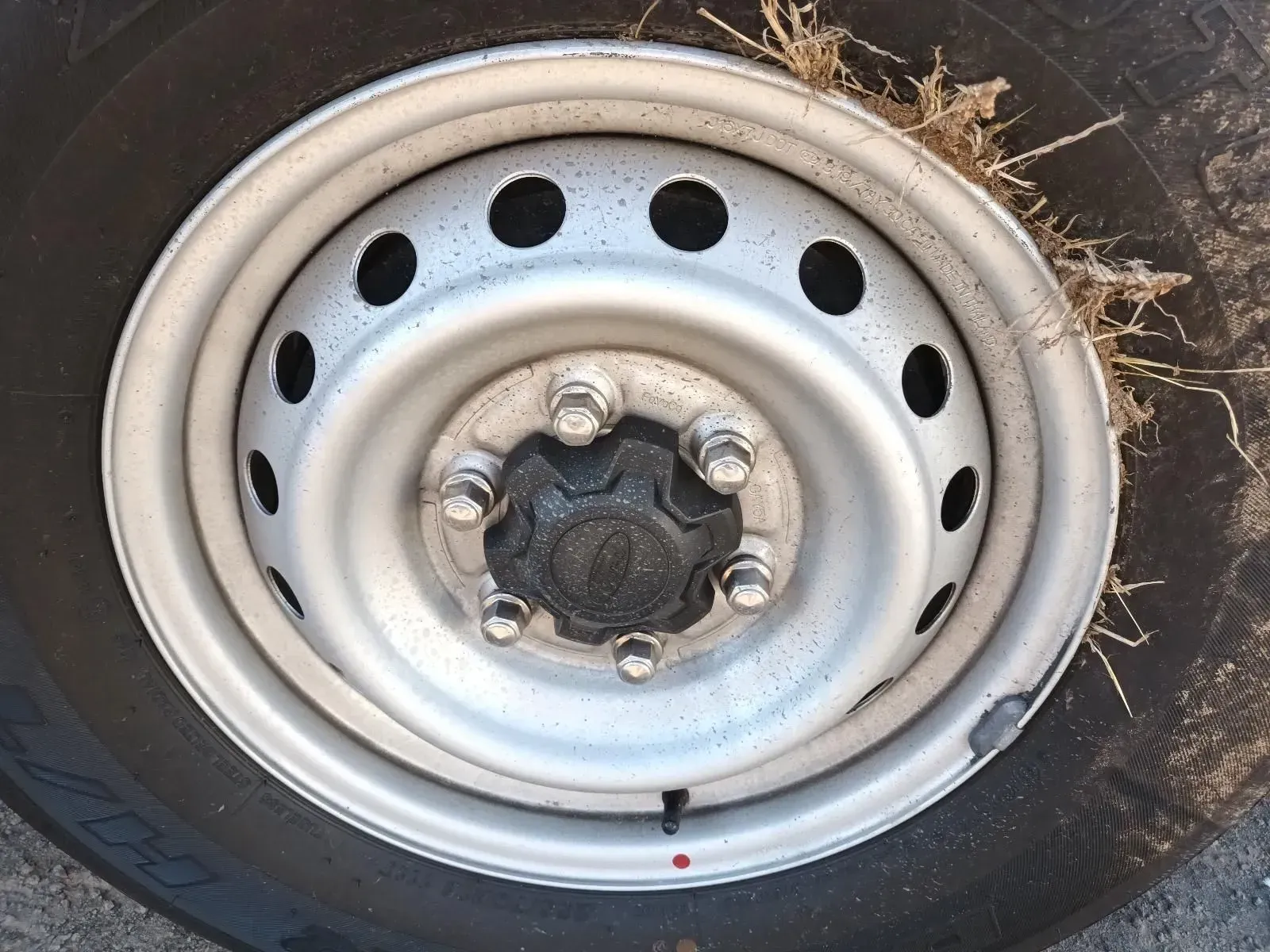 Close-up of a Silver Steel Wheel With Black Tyre, Showing Lug Nuts and Hubcap — South West 4WD Wreckers In Brisbane, QLD