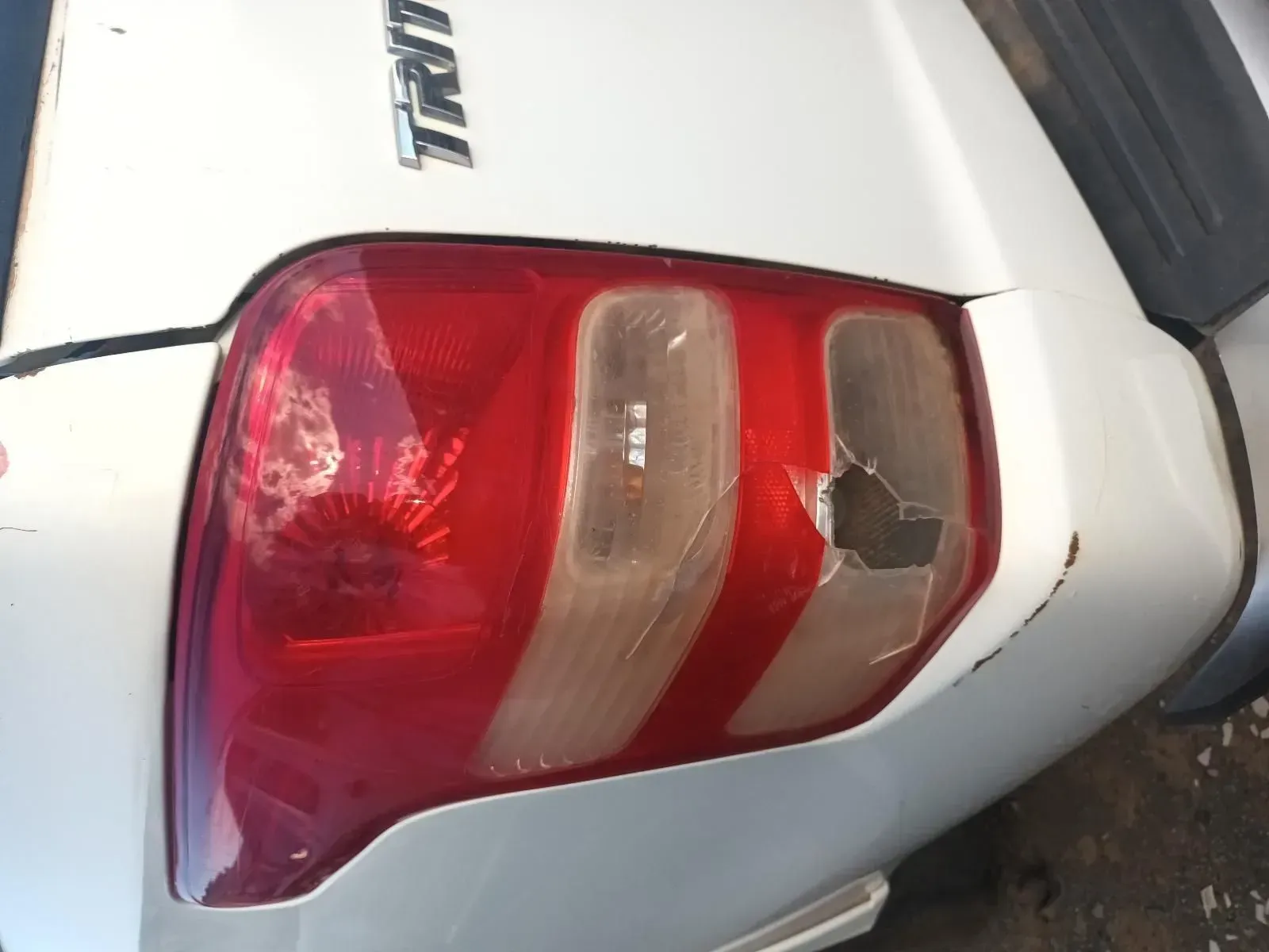 Damaged White Car Tail Light With a Broken Section on a White Car — South West 4WD Wreckers In Brisbane, QLD