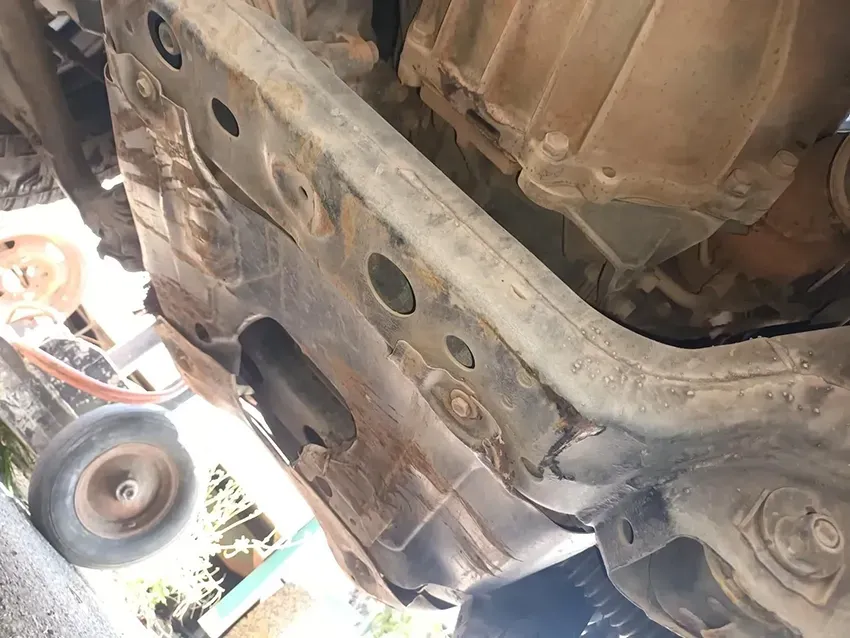A Close Up of the Underside of a Car With a Tractor in the Background — South West 4WD Wreckers In Brisbane, QLD