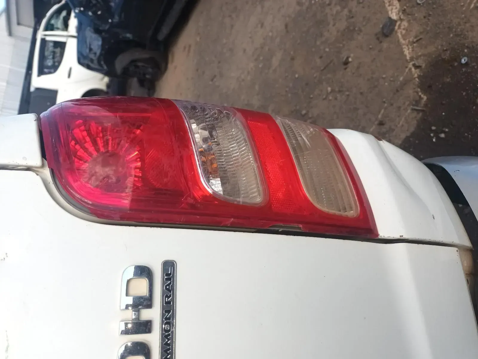 White Car Tail Light With Cracked Lens and Red Lights — South West 4WD Wreckers In Brisbane, QLD