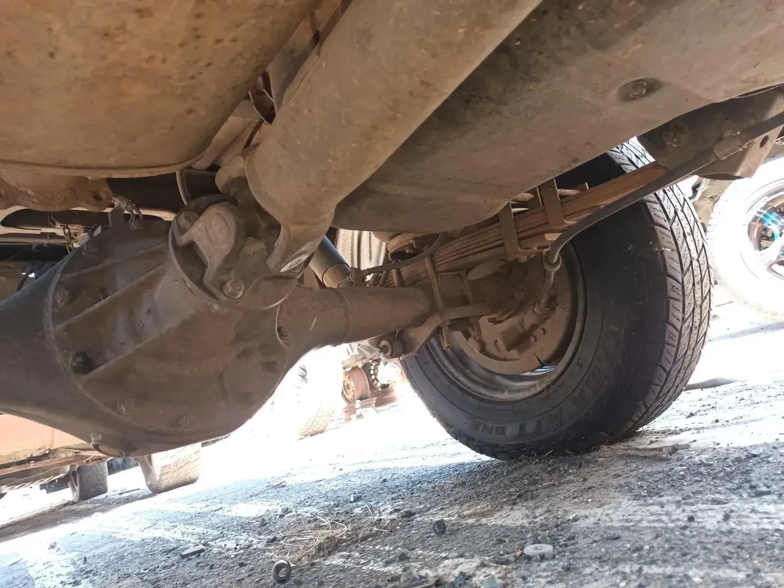 Underside of a Vehicle Showing a Rear Axle, Exhaust Pipe, and Tyre — South West 4WD Wreckers In Brisbane, QLD