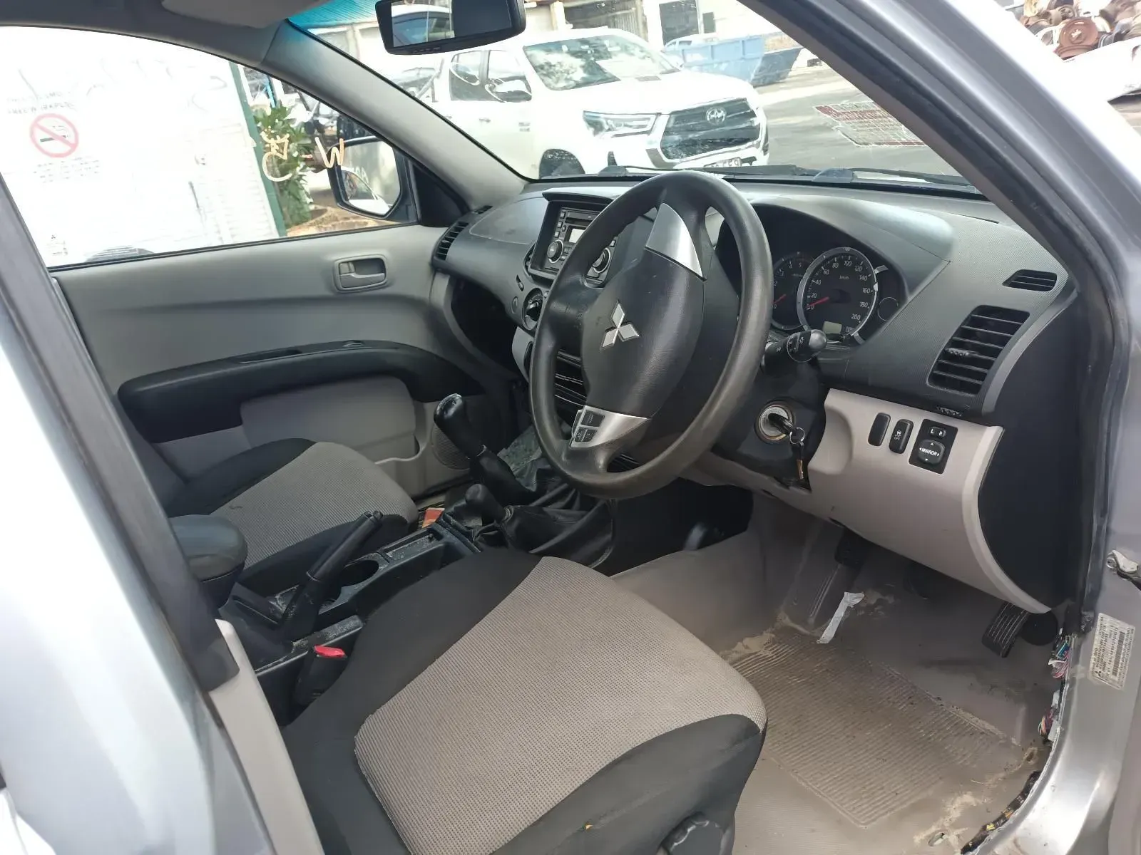Interior of a Grey Mitsubishi Truck, Showing the Steering Wheel — South West 4WD Wreckers In Brisbane, QLD
