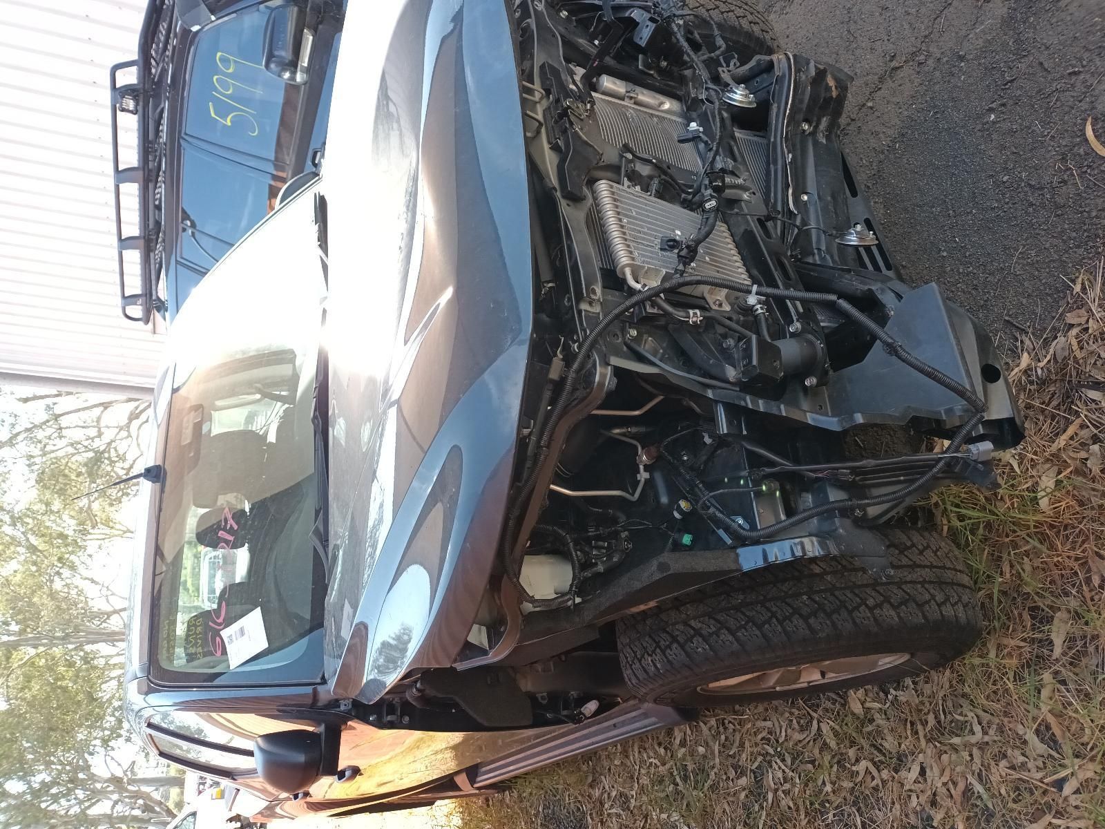 A Damaged Car is Parked on the Side of the Road — South West 4WD Wreckers In Brisbane, QLD