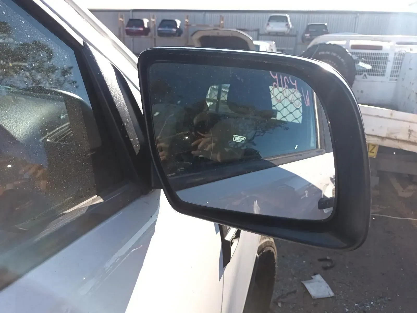 Side Mirror on a White Vehicle, Reflecting a Person and a Blurred Background — South West 4WD Wreckers In Brisbane, QLD