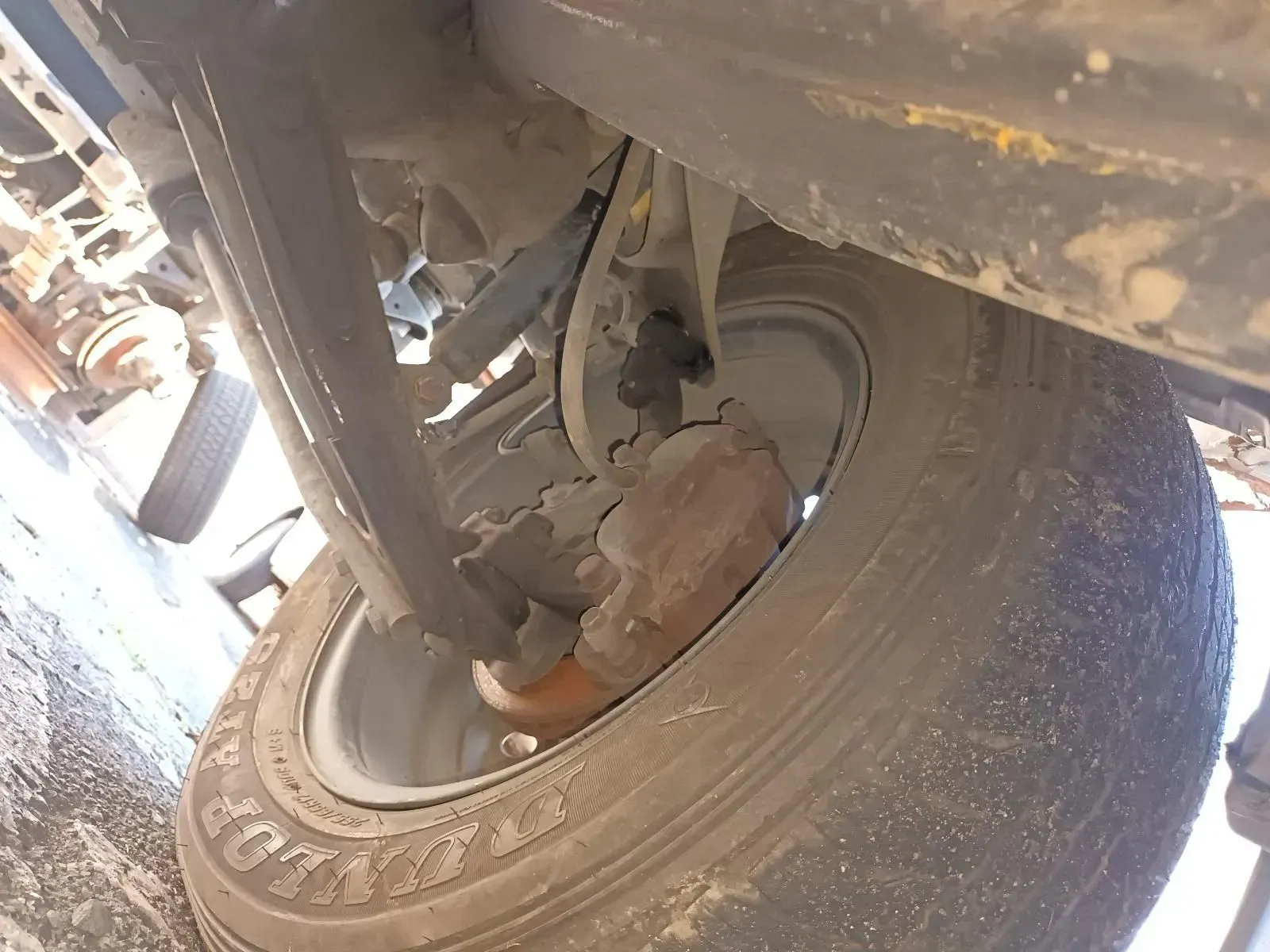 Underside View of a Dirty Truck Tyre and Brake Components — South West 4WD Wreckers In Brisbane, QLD
