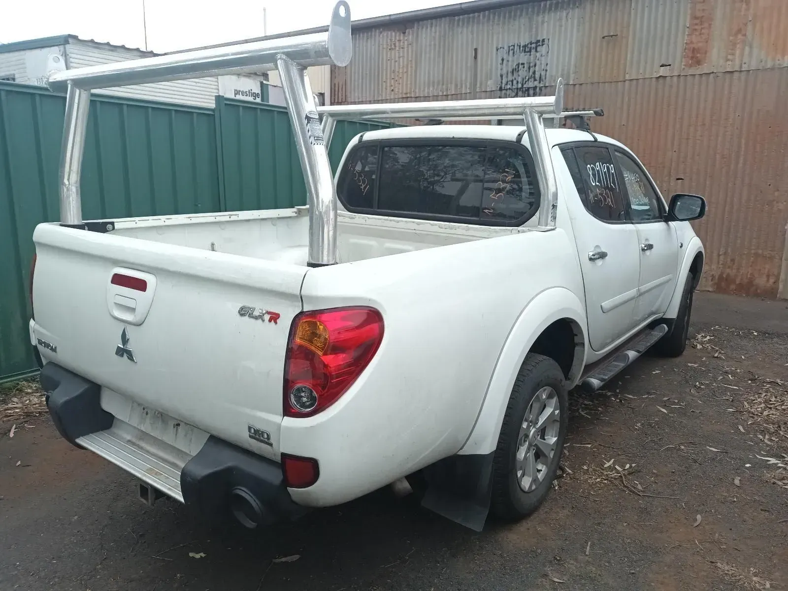 White Mitsubishi Triton Pickup Truck With a Silver Ladder Rack — South West 4WD Wreckers In Brisbane, QLD