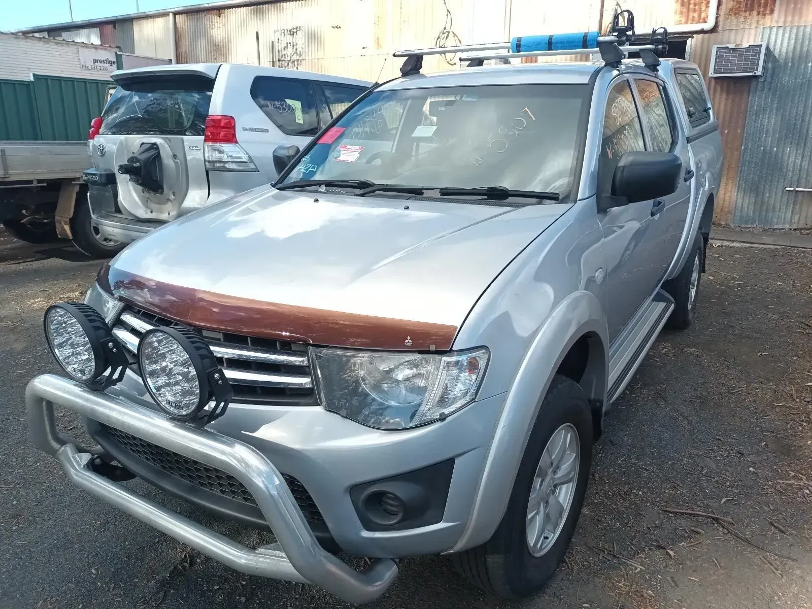 Silver Mitsubishi Triton Pickup Truck With Accessories, in a Yard — South West 4WD Wreckers In Brisbane, QLD