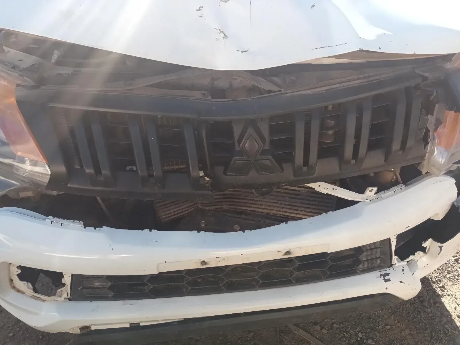 Damaged White Mitsubishi Pickup Truck Front, Grille and Bumper Crushed — South West 4WD Wreckers In Brisbane, QLD