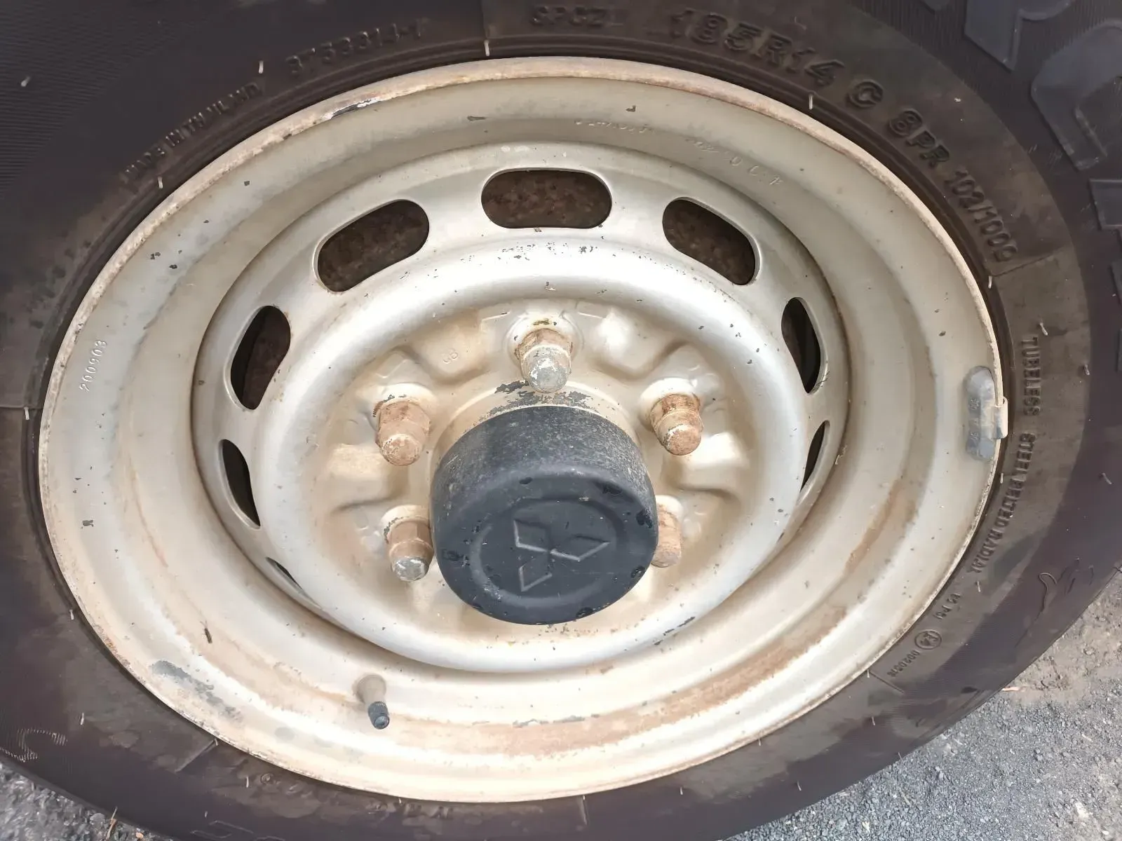 Steel Wheel With a Mitsubishi Logo Hubcap and Lug Nuts — South West 4WD Wreckers In Brisbane, QLD