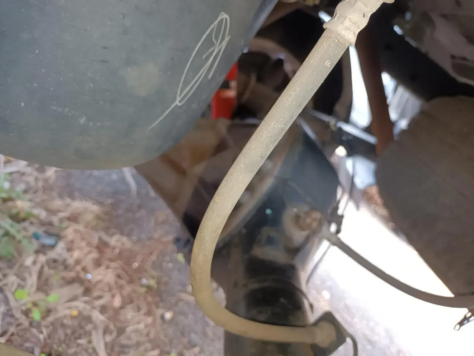 Clear Plastic Hose Near a Car Part, Likely a Brake Line, With Other Parts Visible — South West 4WD Wreckers In Brisbane, QLD
