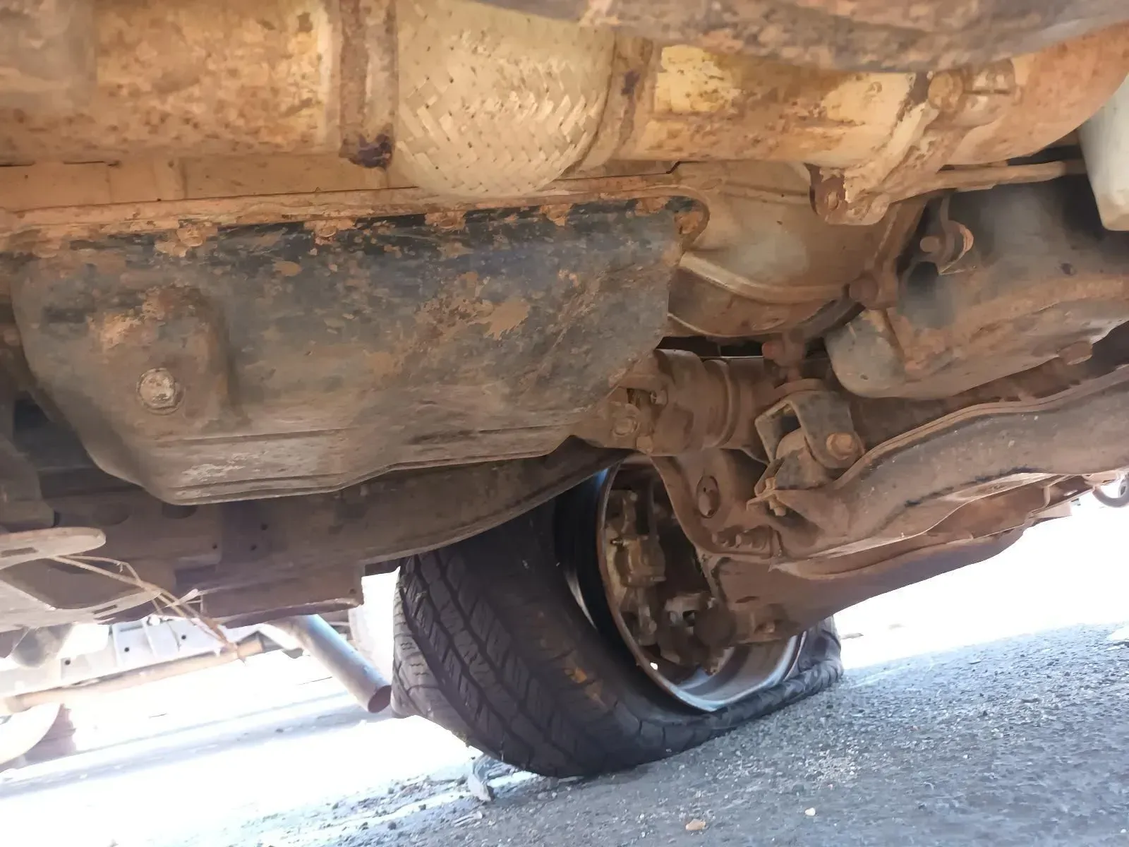 Undercarriage of a Vehicle With a Flat Tyre, Showing Rusty Components — South West 4WD Wreckers In Brisbane, QLD