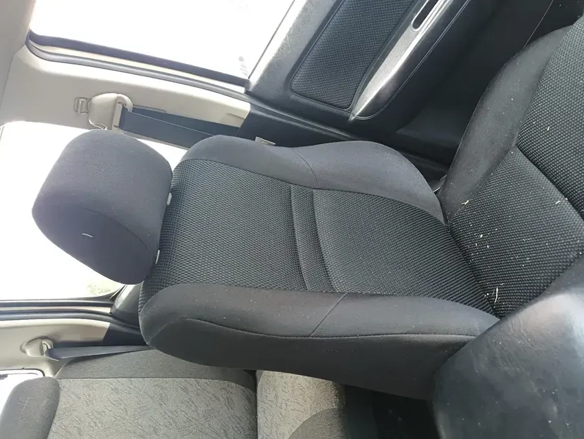 A Black Car Seat With a Headrest is Sitting in a Car With the Door Open — South West 4WD Wreckers In Brisbane, QLD