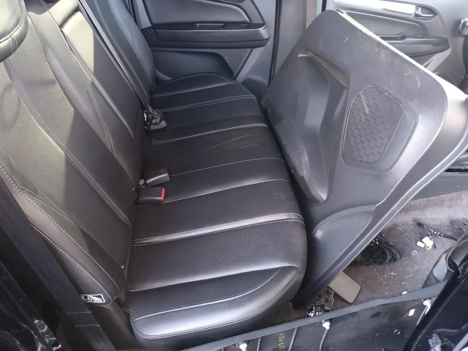Black Leather Car Back Seat With a Door Panel Leaning Against It — South West 4WD Wreckers In Brisbane, QLD