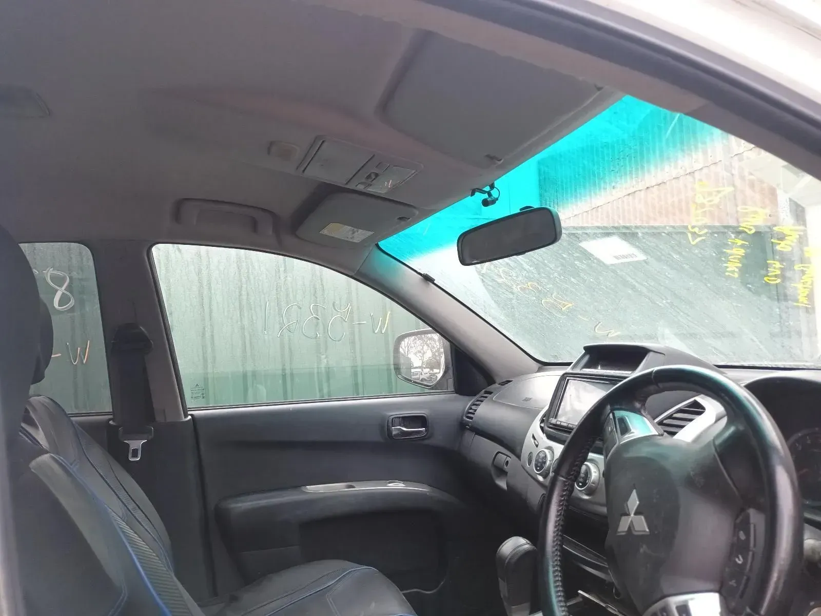 Interior View of a Mitsubishi Car, Showing Dashboard, Seats, and Windscreen — South West 4WD Wreckers In Brisbane, QLD