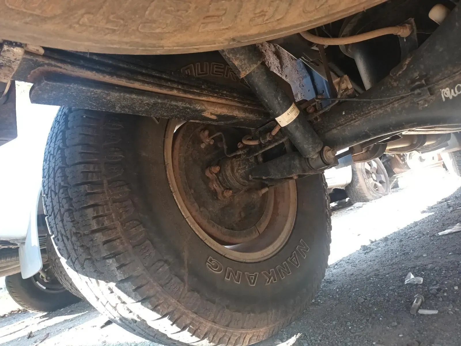 Undercarriage of a Truck Showing a Rear Tyre, Suspension, and Shock Absorber — South West 4WD Wreckers In Brisbane, QLD