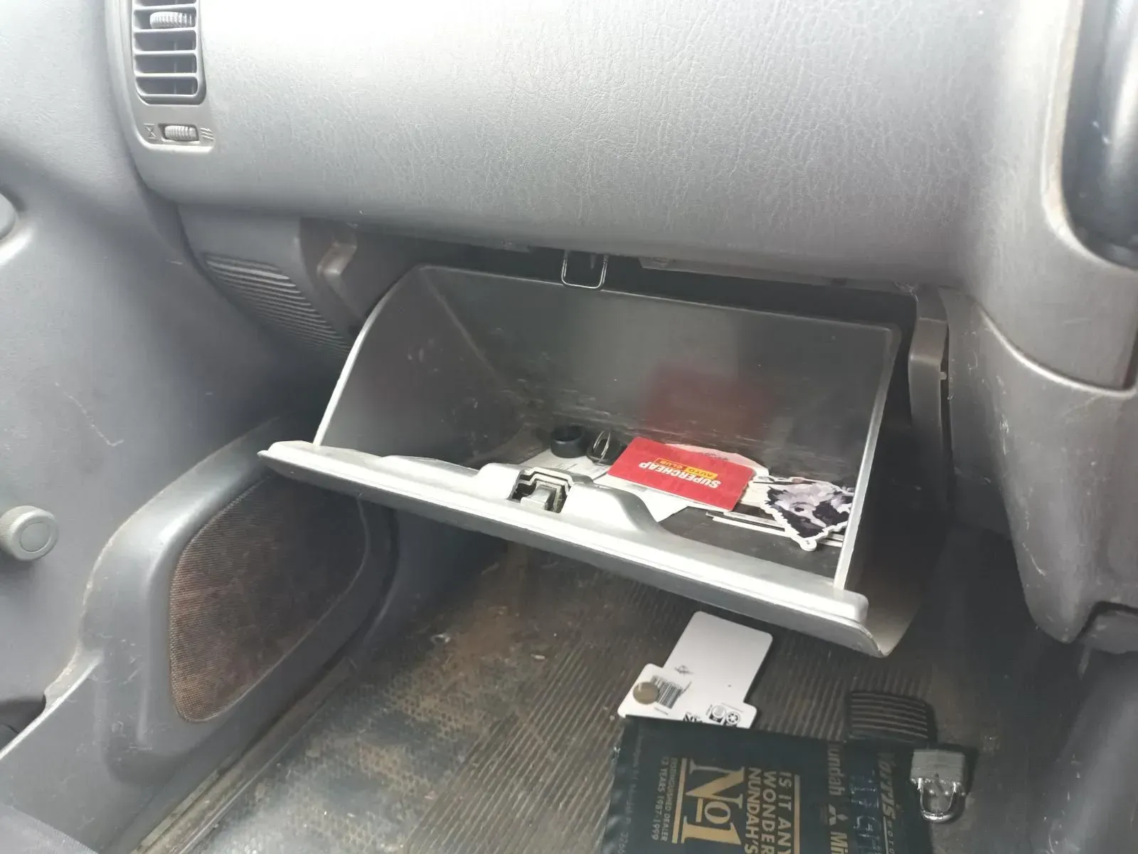 Open Car Glove Compartment With Papers and Items Inside — South West 4WD Wreckers In Brisbane, QLD