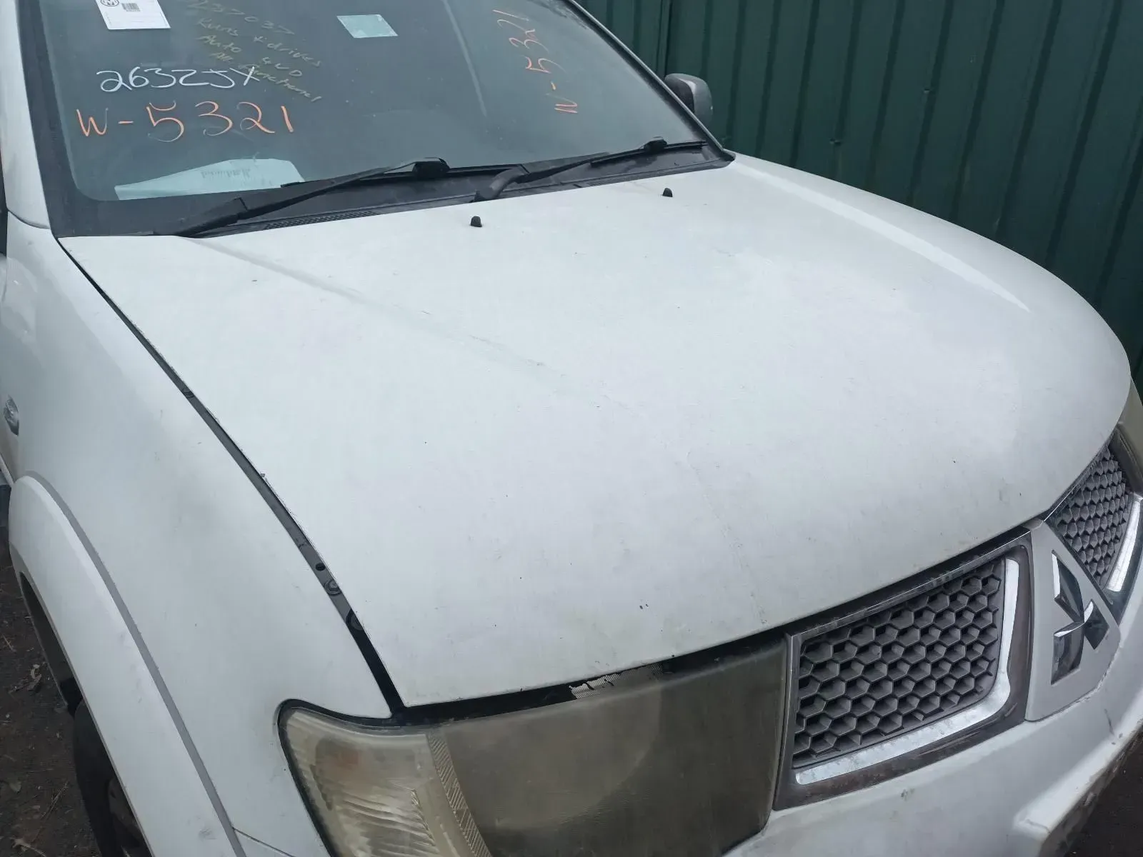 White Mitsubishi Truck Hood With Headlight and Grille Visible — South West 4WD Wreckers In Brisbane, QLD