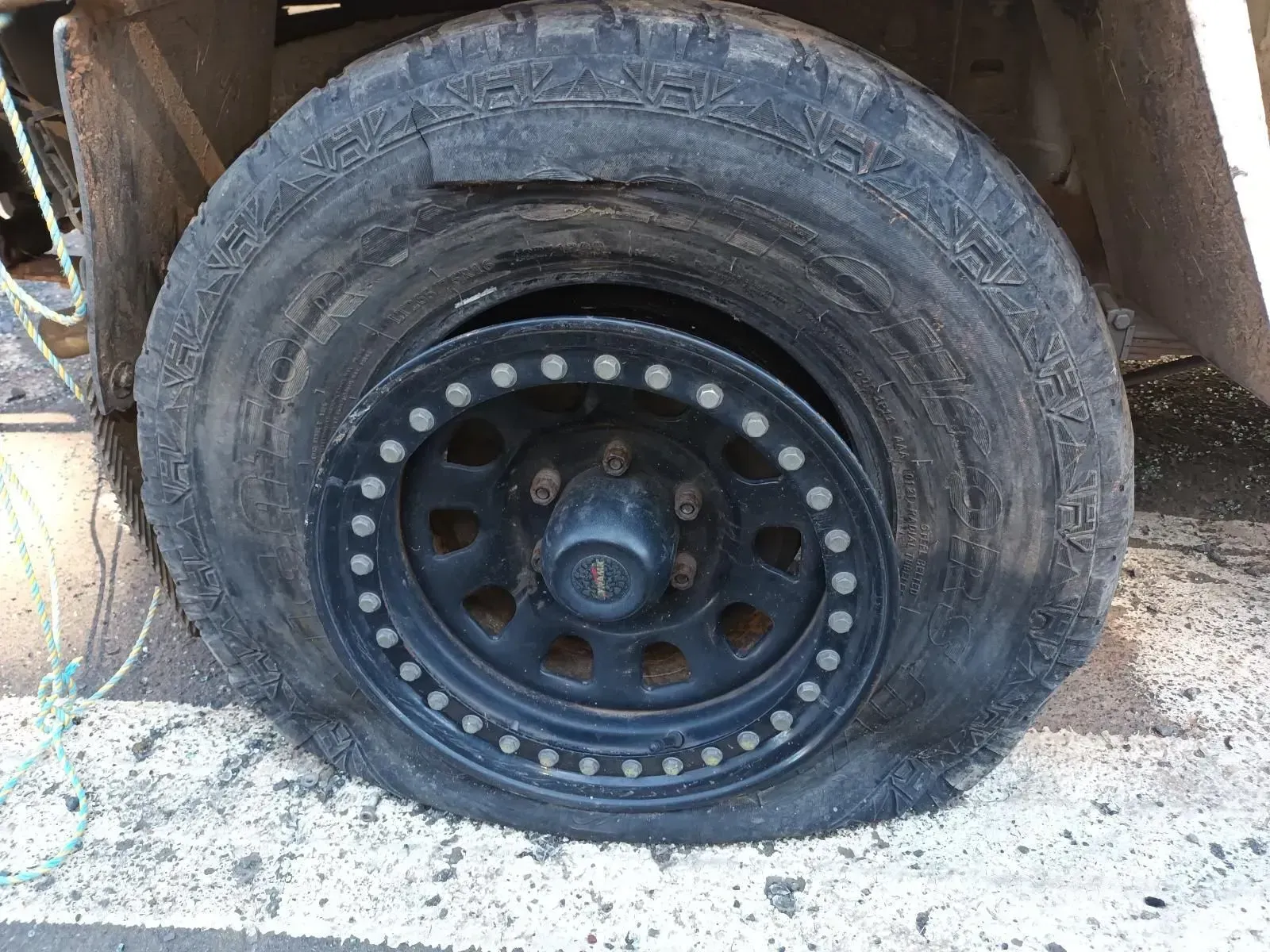 Flat, Deflated Black Tyre on a Black Wheel — South West 4WD Wreckers In Brisbane, QLD