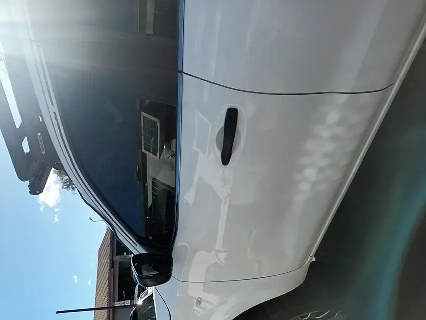 A White Car is Parked in a Driveway on a Sunny Day — South West 4WD Wreckers In Brisbane, QLD