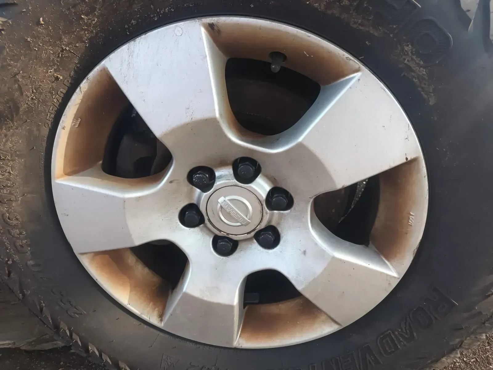 Silver Nissan Wheel With Mud Stains — South West 4WD Wreckers In Brisbane, QLD