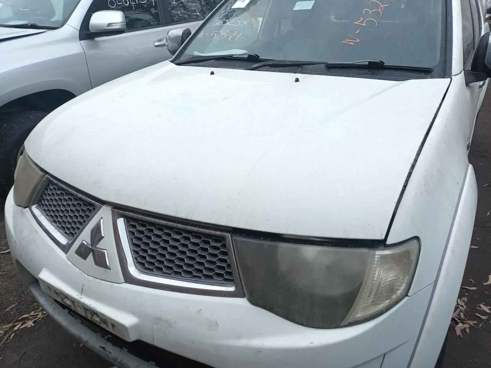 White Mitsubishi Truck Front View, With Gray Grill and Headlights — South West 4WD Wreckers In Brisbane, QLD
