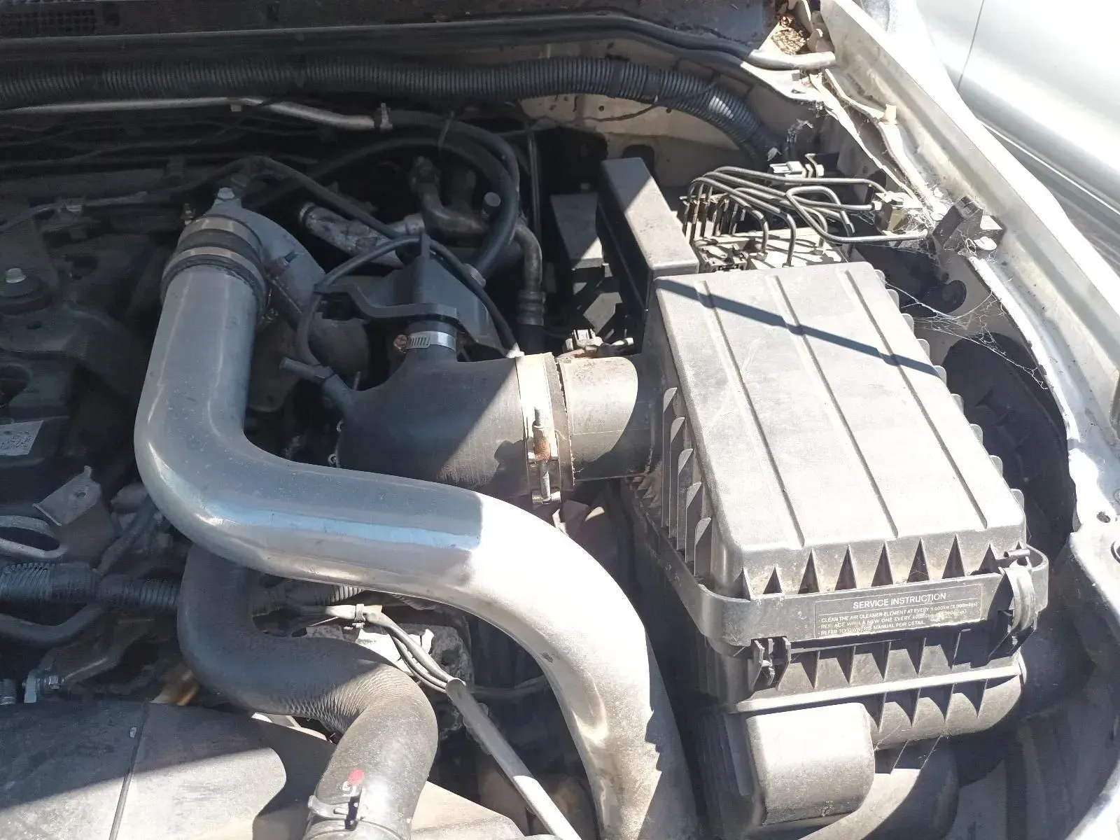 Engine Bay With a Large Black Air Filter Box and Silver Intake Tubing — South West 4WD Wreckers In Brisbane, QLD