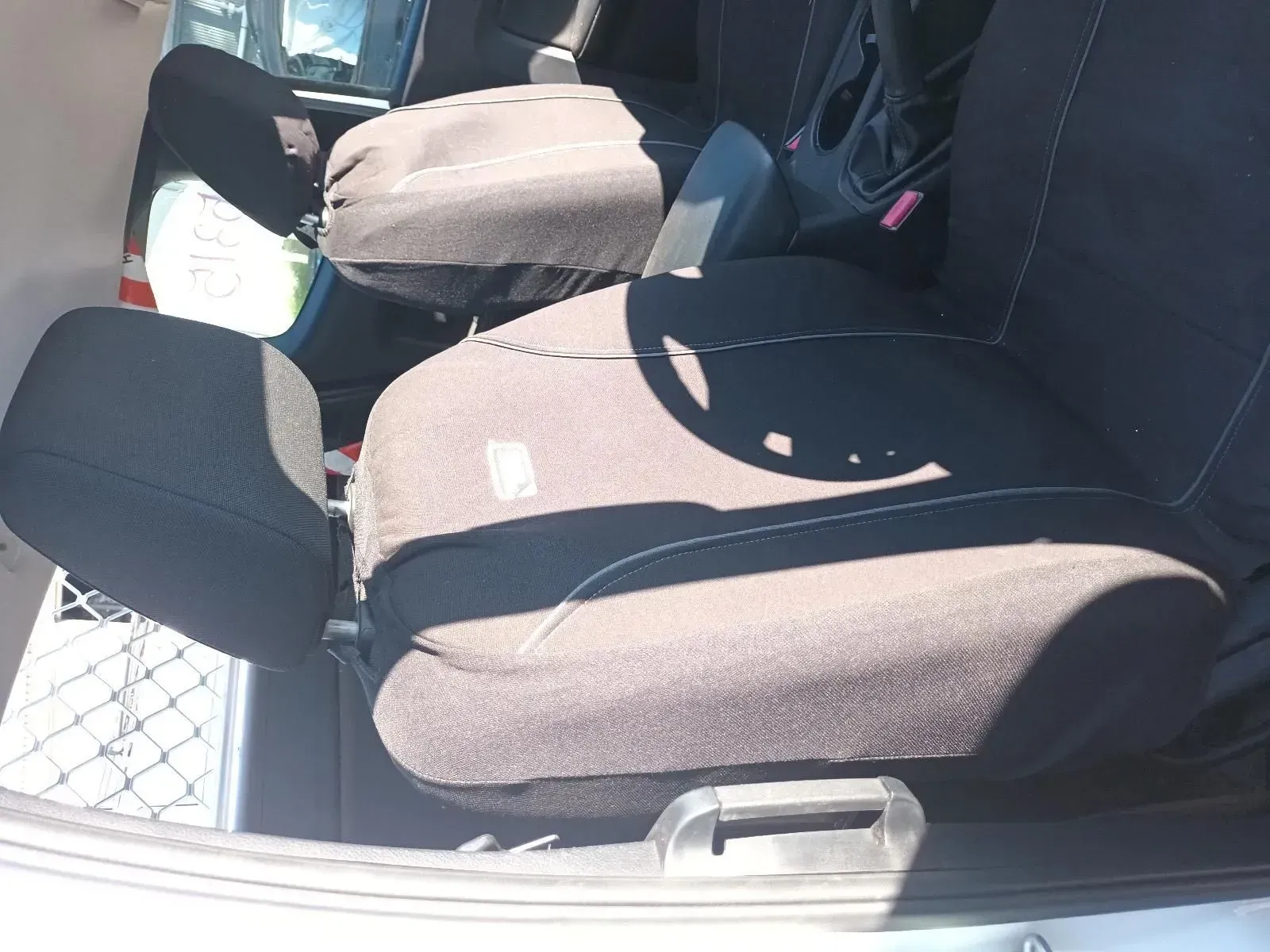 Car Seats Folded in the Back of a Vehicle, Black Fabric With White Stitching — South West 4WD Wreckers In Brisbane, QLD