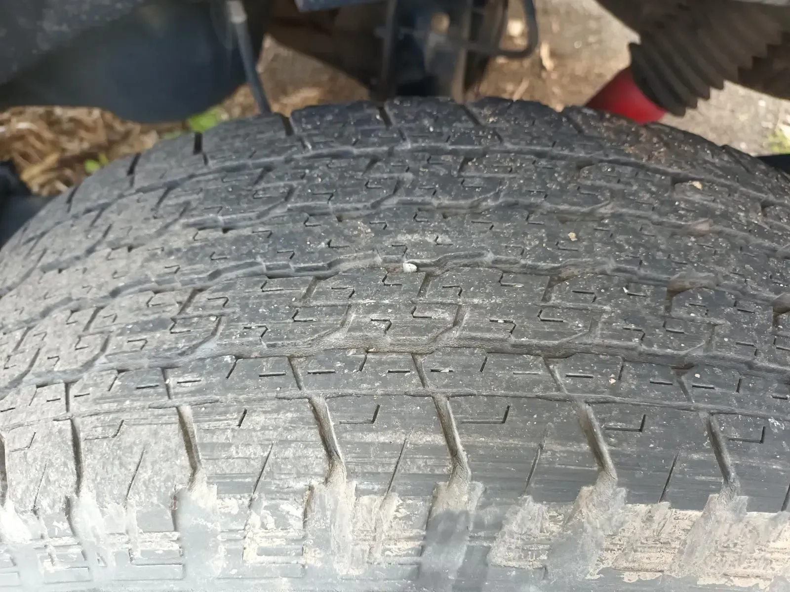 Close-up of a Worn Black Tyre With Grooves and Dirt, Suggesting a Vehicle — South West 4WD Wreckers In Brisbane, QLD