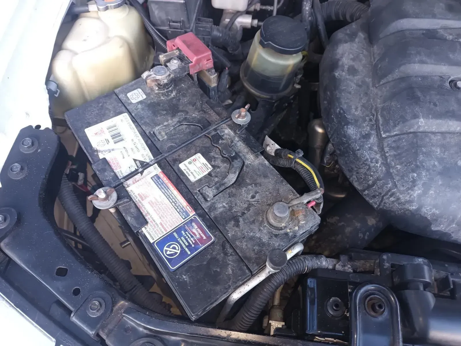 A Dirty Car Battery in an Engine Compartment — South West 4WD Wreckers In Brisbane, QLD