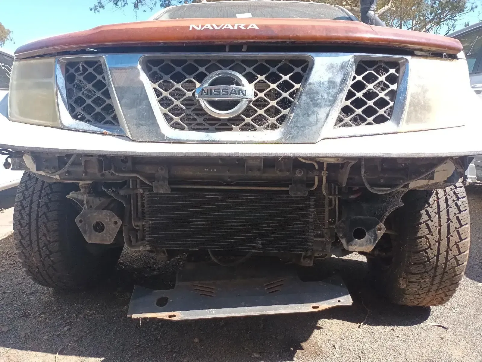 Brown Nissan Navara With Front Bumper Removed, Revealing the Radiator — South West 4WD Wreckers In Brisbane, QLD