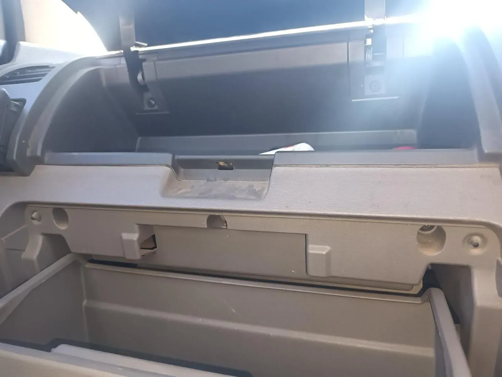 Open Car Glove Compartment, Empty, Beige Plastic, Lit by Sunlight — South West 4WD Wreckers In Brisbane, QLD
