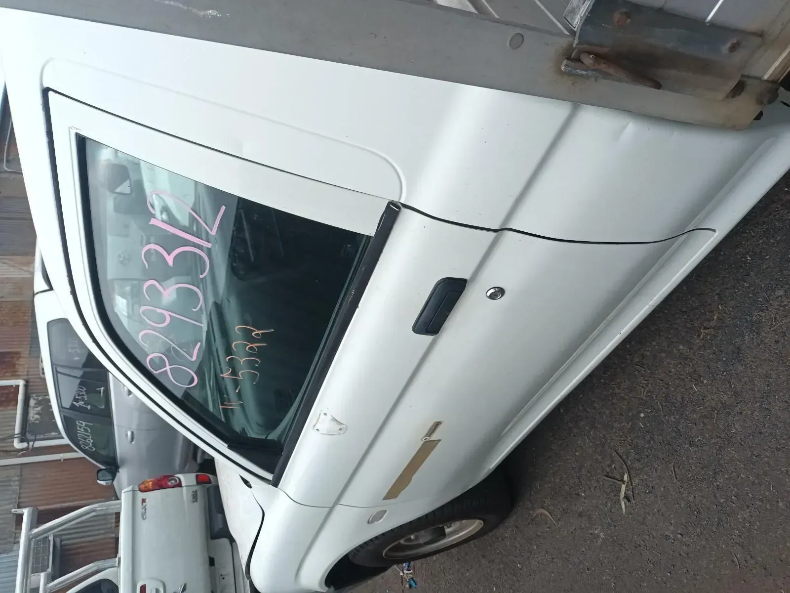White Pickup Truck Door With Black Window Frame and Handle, in a Salvage Yard — South West 4WD Wreckers In Brisbane, QLD