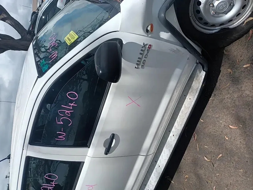 A White Truck is Parked on the Side of the Road — South West 4WD Wreckers In Brisbane, QLD