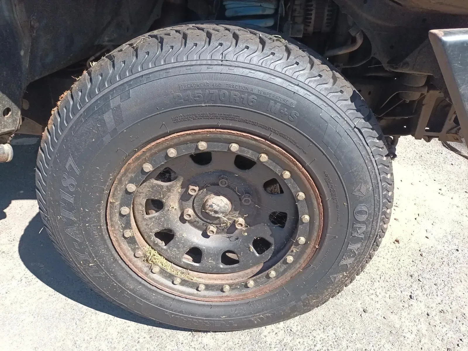 Black Tyre Mounted on a Black Wheel, Part of a Vehicle, Outdoors — South West 4WD Wreckers In Brisbane, QLD