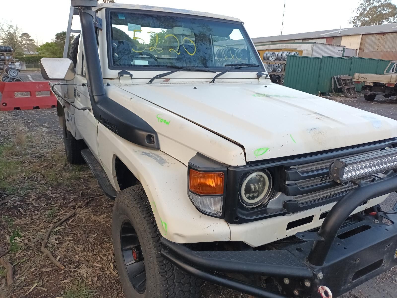 A White Truck with a Black Bumper is Parked in a Lot — South West 4WD Wreckers in Harristown, QLD 