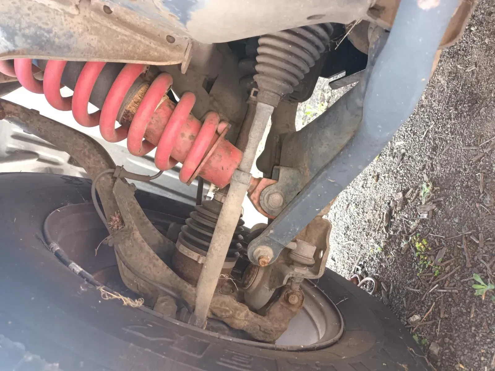 Red Suspension Spring and Shock Absorber on Vehicle's Front Wheel — South West 4WD Wreckers In Brisbane, QLD