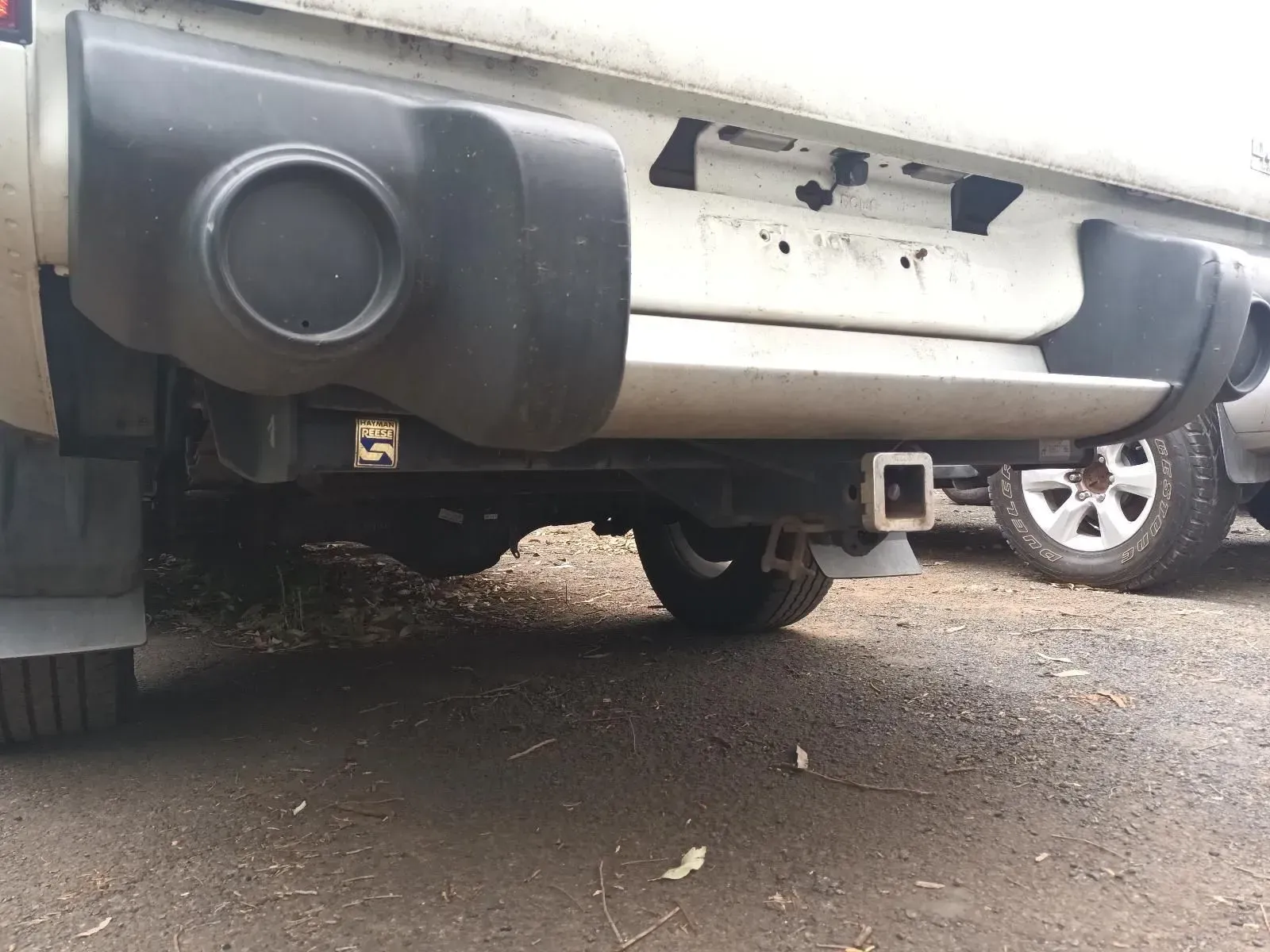 Rear Bumper of a White Truck With a Trailer Hitch, Angled From Below — South West 4WD Wreckers In Brisbane, QLD