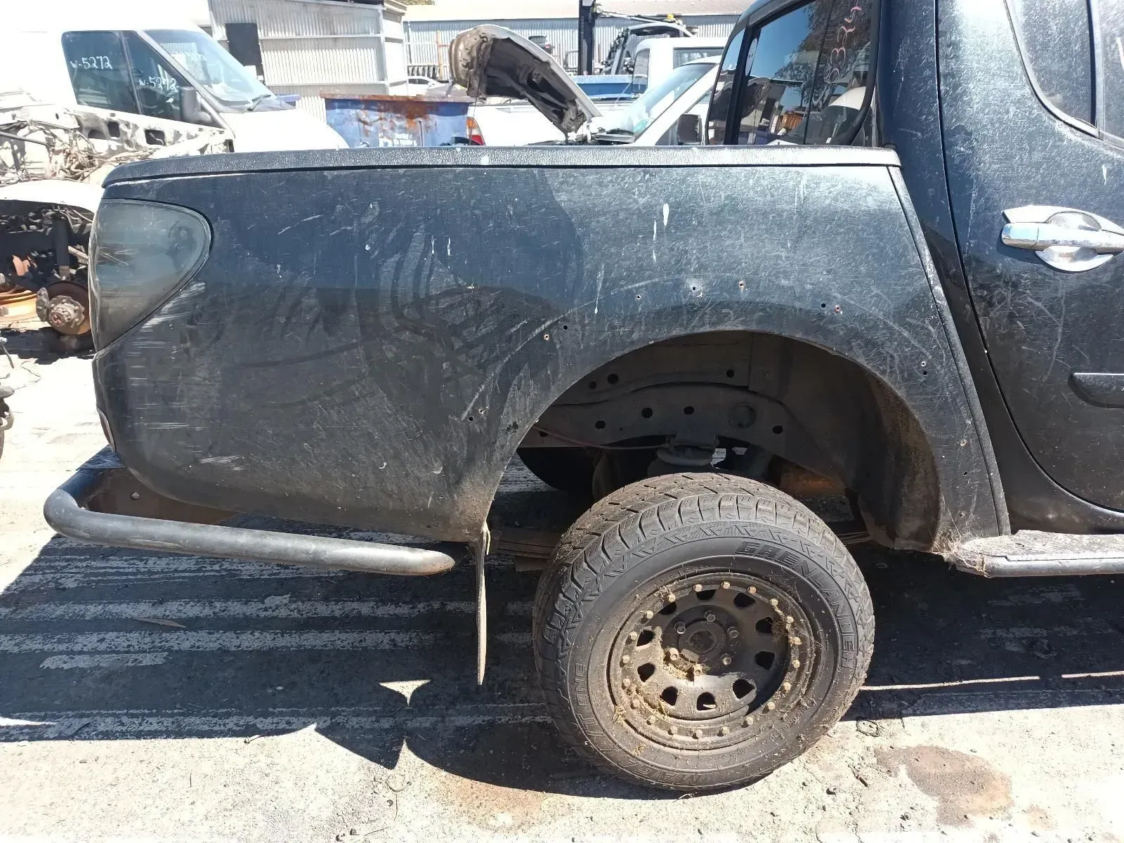 Black Pickup Truck Rear Quarter Panel and Wheel, Outdoors — South West 4WD Wreckers In Brisbane, QLD