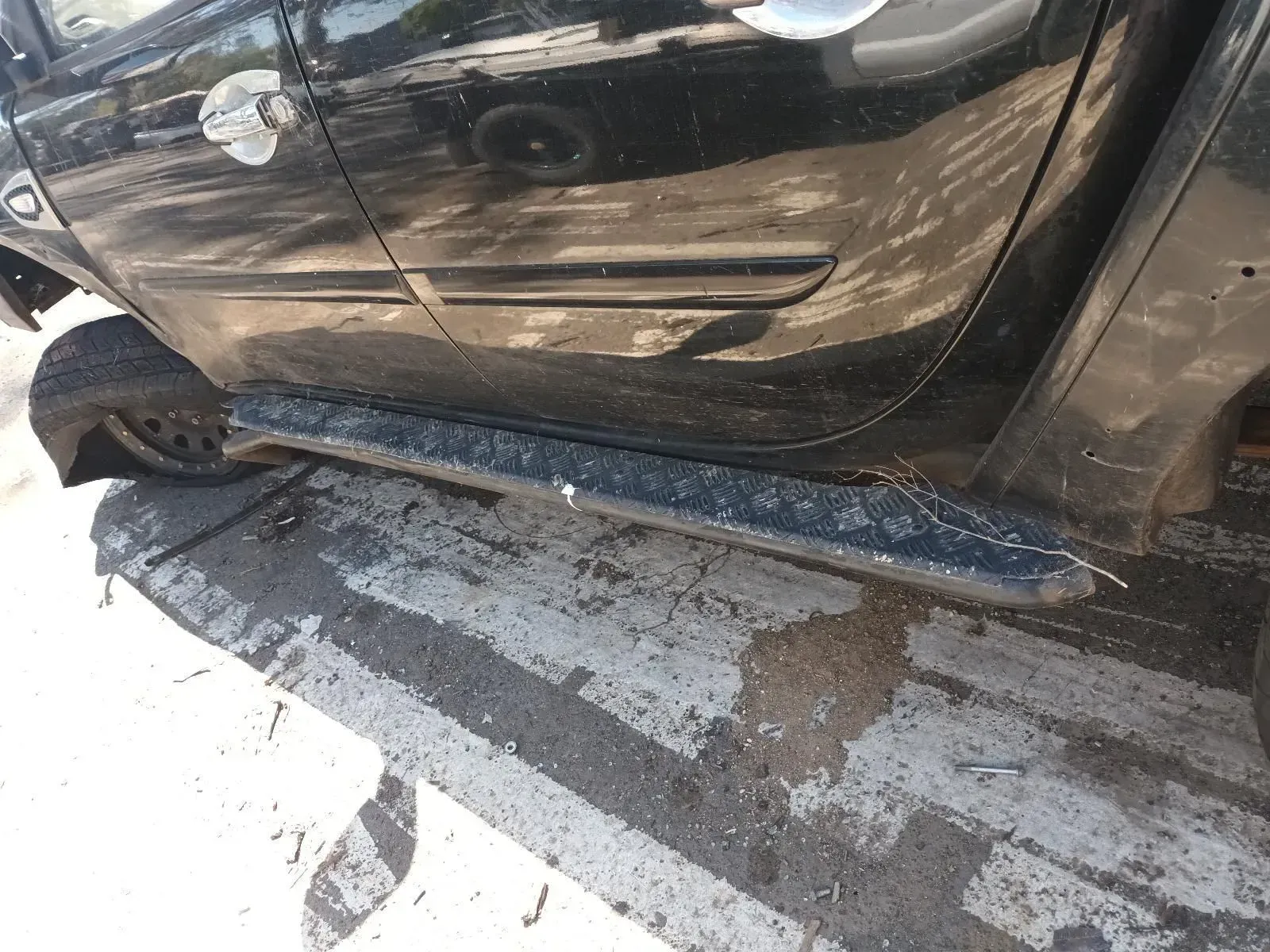 Black Pickup Truck Side Step, Partially Visible on Asphalt — South West 4WD Wreckers In Brisbane, QLD